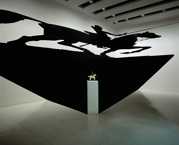Regina Silveira
Saint's Paradox, 2002
vinyl cut, wooden base with wood saint, walls: 5 x 18m; floor: 18 x 4m
Installation at the Guggenheim Museum, New York; Photo- Mauro Restiffe