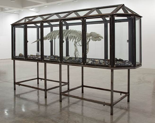 Mark Dion
Trichechus manatus (Cast Manatee Skeleton), 2013
Glass and steel vitrine, tar, numerous small trinkets, 72 x 40 x 176 in.