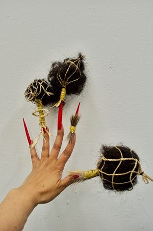 Natalie Ball
Bone Thrower (photograph and installation series), 2018
tule cordage, deer fur, sinew thread, braiding hair, rubber bands, acrylic nails, 8 x 11 in.